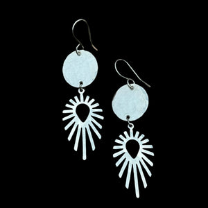 Handmade Solstice Trail Earrings featuring silver pendants with a circular accent, hanging from hypoallergenic sterling silver ear wires.