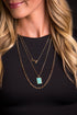 Spirit of the West Necklace featuring a 24-inch layered gold chain with arrow accents and a turquoise bar pendant, blending Western charm with modern elegance.