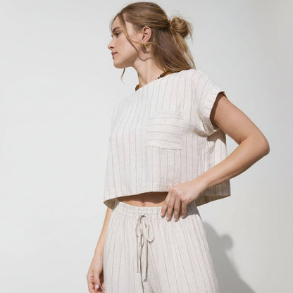 Cropped pinstripe top with short cuffed sleeves, chest pocket, and back button detail in a lightweight linen blend
