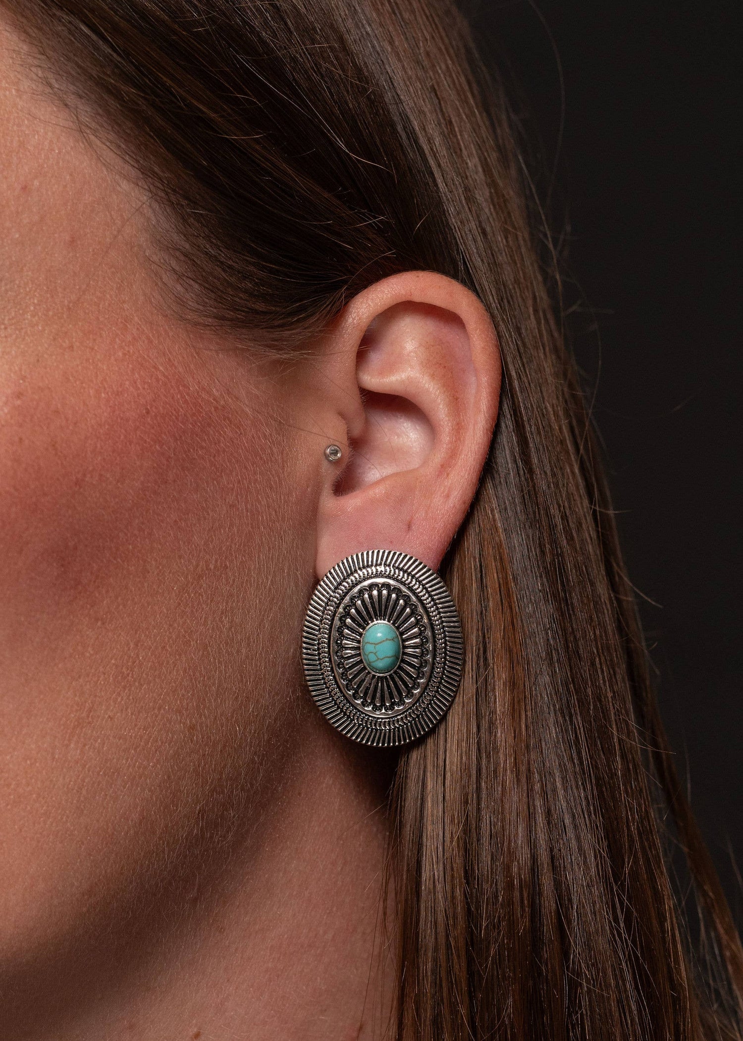 urquoise Mesa Earrings featuring 1.5-inch oval silver conchos accented with a turquoise stone, showcasing classic Southwestern elegance.