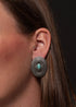 urquoise Mesa Earrings featuring 1.5-inch oval silver conchos accented with a turquoise stone, showcasing classic Southwestern elegance.