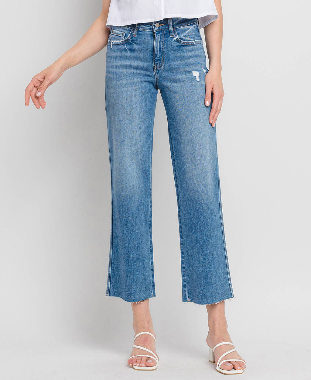 Western Drift Jeans – High-rise slim wide-leg jeans with comfort stretch denim, featuring a raw hem, slight distressing, and ankle-length cut. Flattering fit with a 10" rise and 28" inseam.