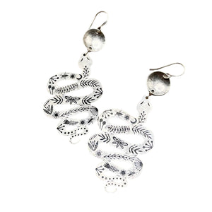 Handmade Western Rattler Earrings featuring intricately stamped sterling silver-plated brass snake pendants with nature-inspired detailing, hanging from hypoallergenic sterling silver ear wires.